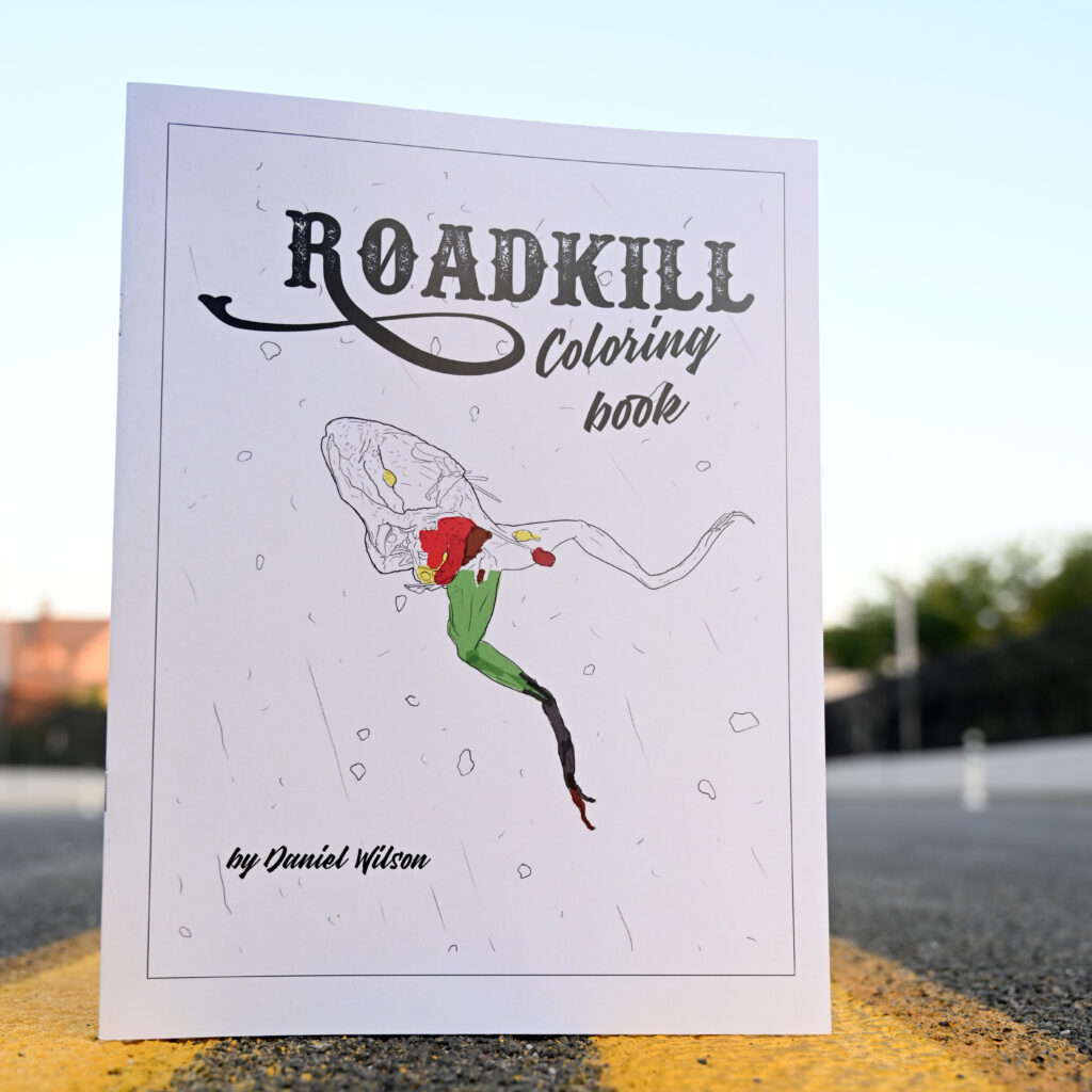The Roadkill Coloring Book standing in the middle of a street